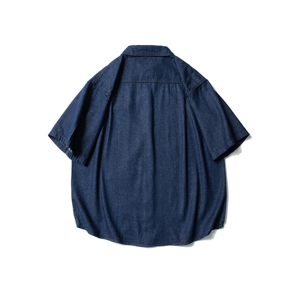 Back view of dark blue short-sleeve denim shirt with yoke seam and curved hem
