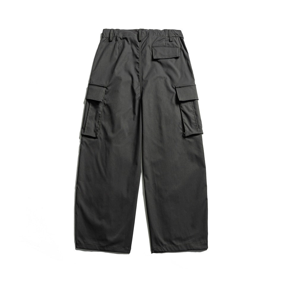 Back view of charcoal wide-leg cargo pants with flap pockets at the sides and rear.