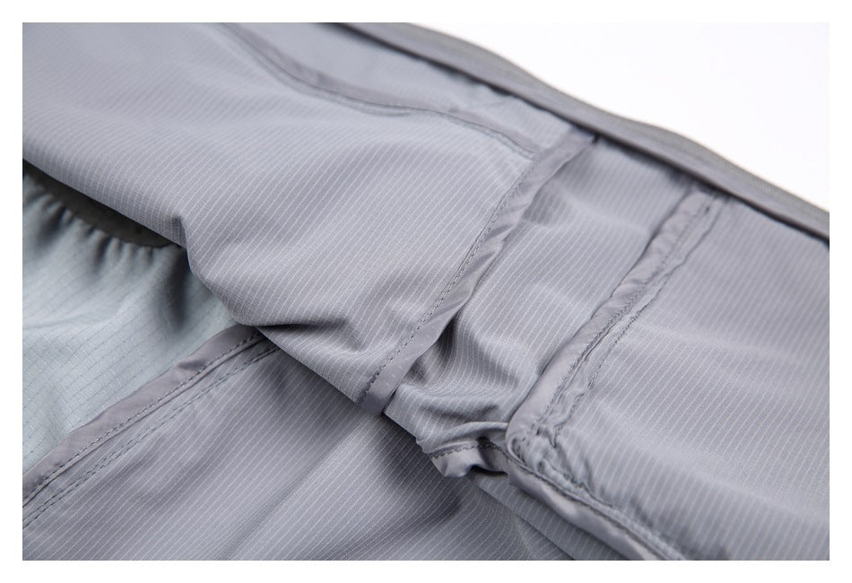 Close-up of the inside of a gray striped garment, showing layered panels and stitched seams.