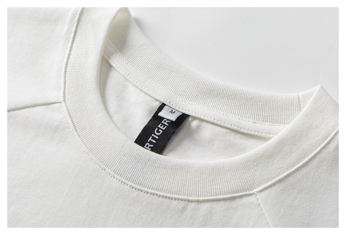 Close-up of a white T-shirt's ribbed crew neckline and inner size label.