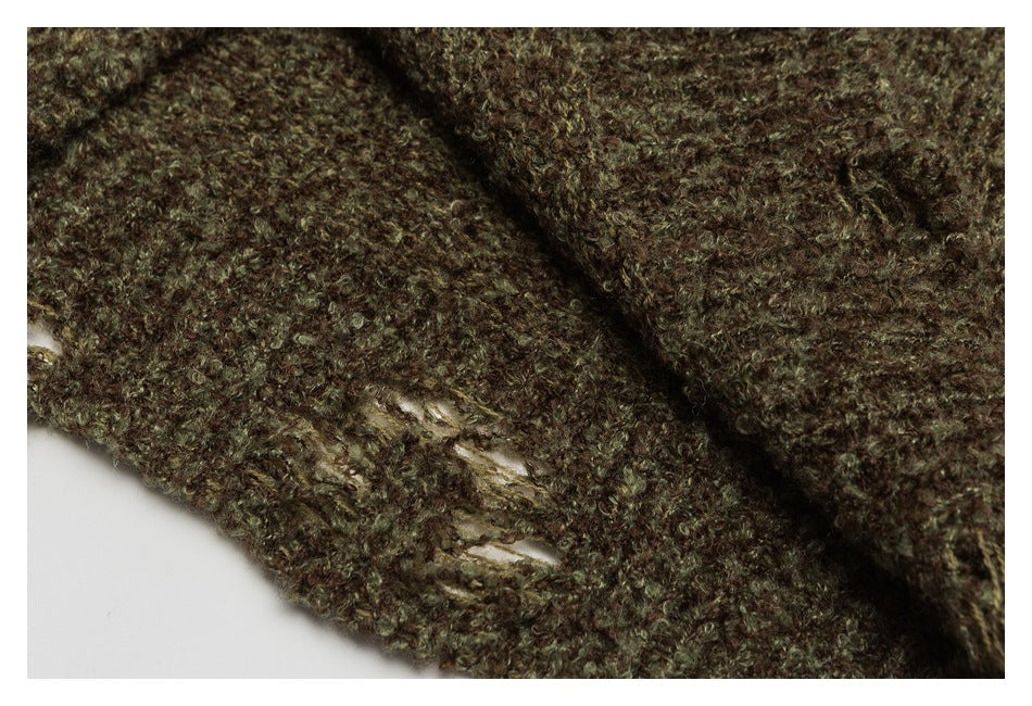 Close-up of brown and olive fuzzy knit with several small openings in the stitching.