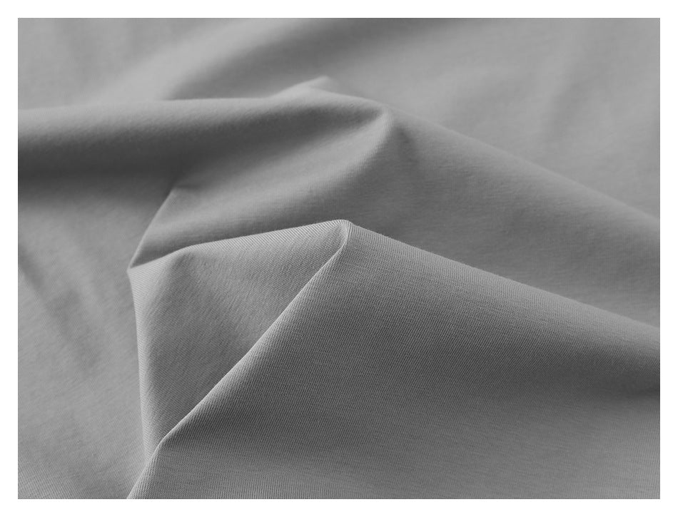 Close-up showing the gray polo shirt fabric draped into soft folds.