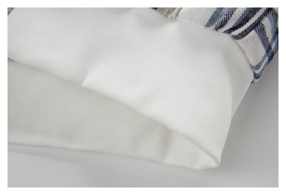Close-up of a wide white rib-knit band at the edge of the plaid jacket.