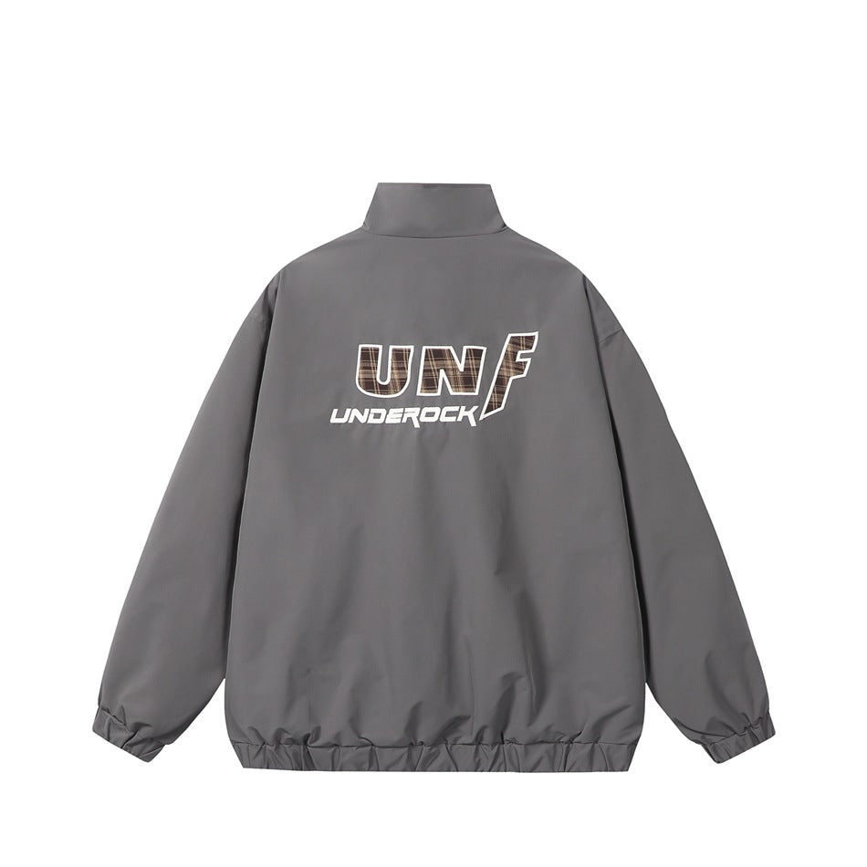 Gray stand-collar jacket, back view, with large white and plaid-filled letter graphic and elasticated cuffs and hem