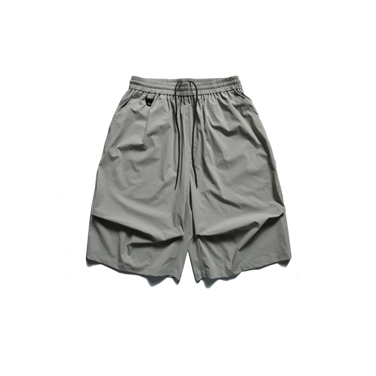 Gray knee-length shorts with elastic drawstring waist, D-ring, side pockets and pleated front detail, flat lay