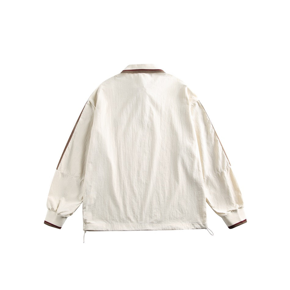 Back view of an ivory pullover with brown sleeve accents, striped collar and cuffs, and an adjustable drawcord hem.