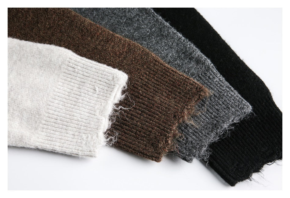 Close-up of ribbed sweater cuffs in light gray, brown, charcoal gray, and black.