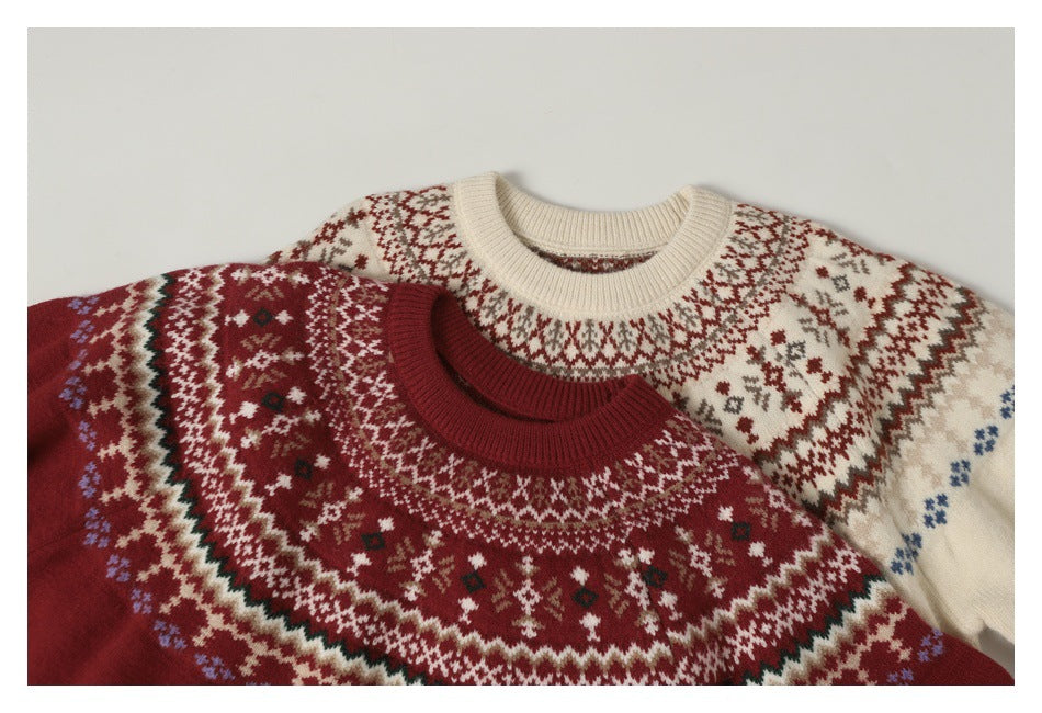 Two laid-flat patterned crewneck sweaters: one cream with rust motifs and one deep red with cream geometric bands.