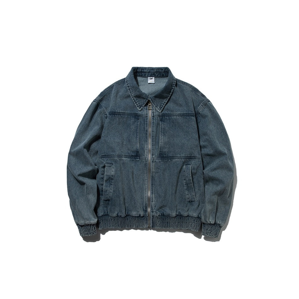 Washed blue denim zip-front jacket with pointed collar, chest panels, front pockets and ribbed hem, flat front view