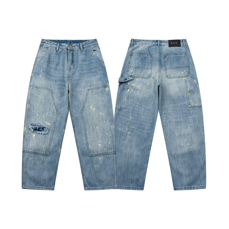 Front and back views of light blue wide-leg jeans with utility pockets, scattered distressed marks and a torn knee.