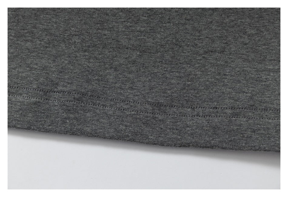 Close-up of a gray garment hem with a visible line of stitching.