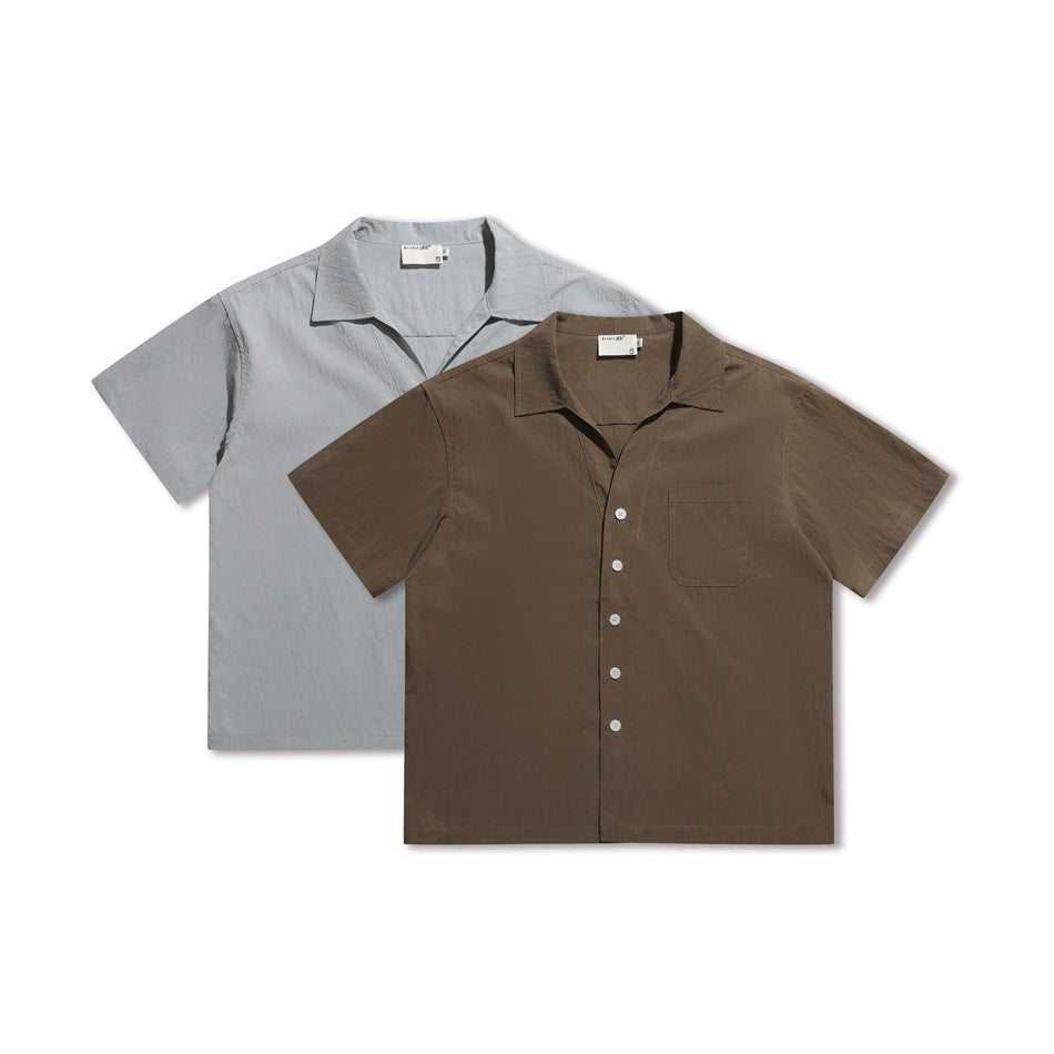 Two short-sleeve button-up shirts shown from the front: one light gray and one brown, each with a chest pocket.