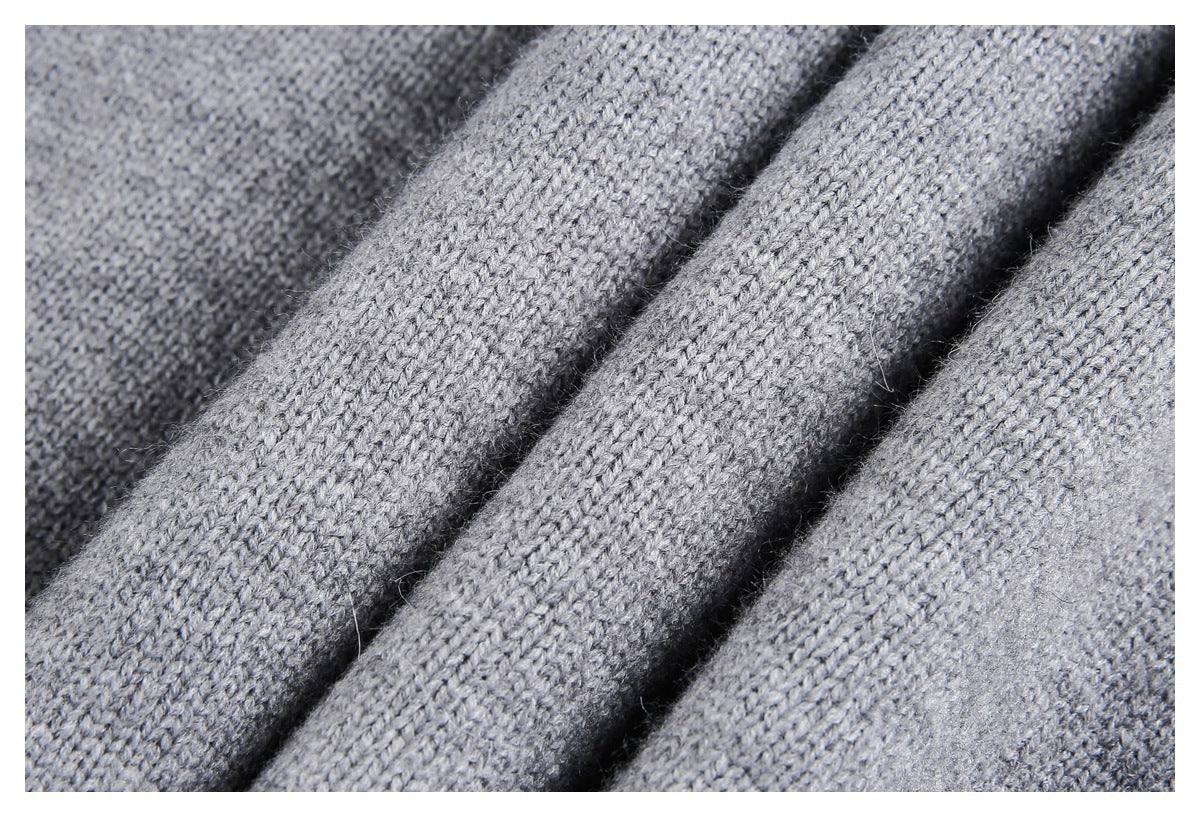Close-up of gray knitted fabric showing its fine looped texture and folds.