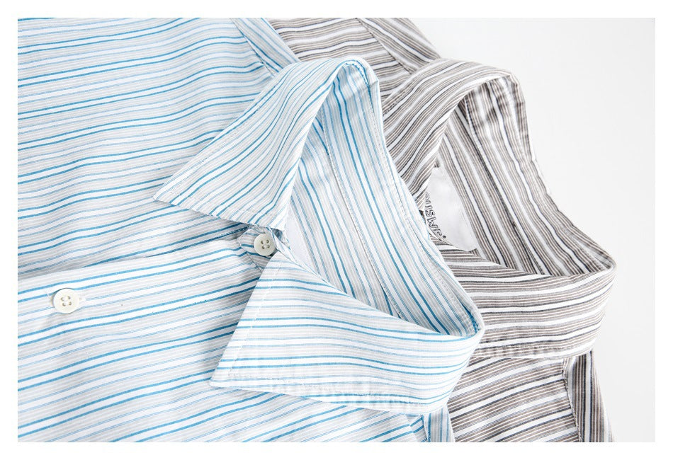Close-up of the collars and buttons on blue-and-white and gray-and-white striped shirts.
