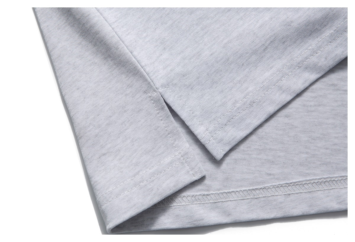 Close-up of the light gray garment's stitched hems and overlocked edge.