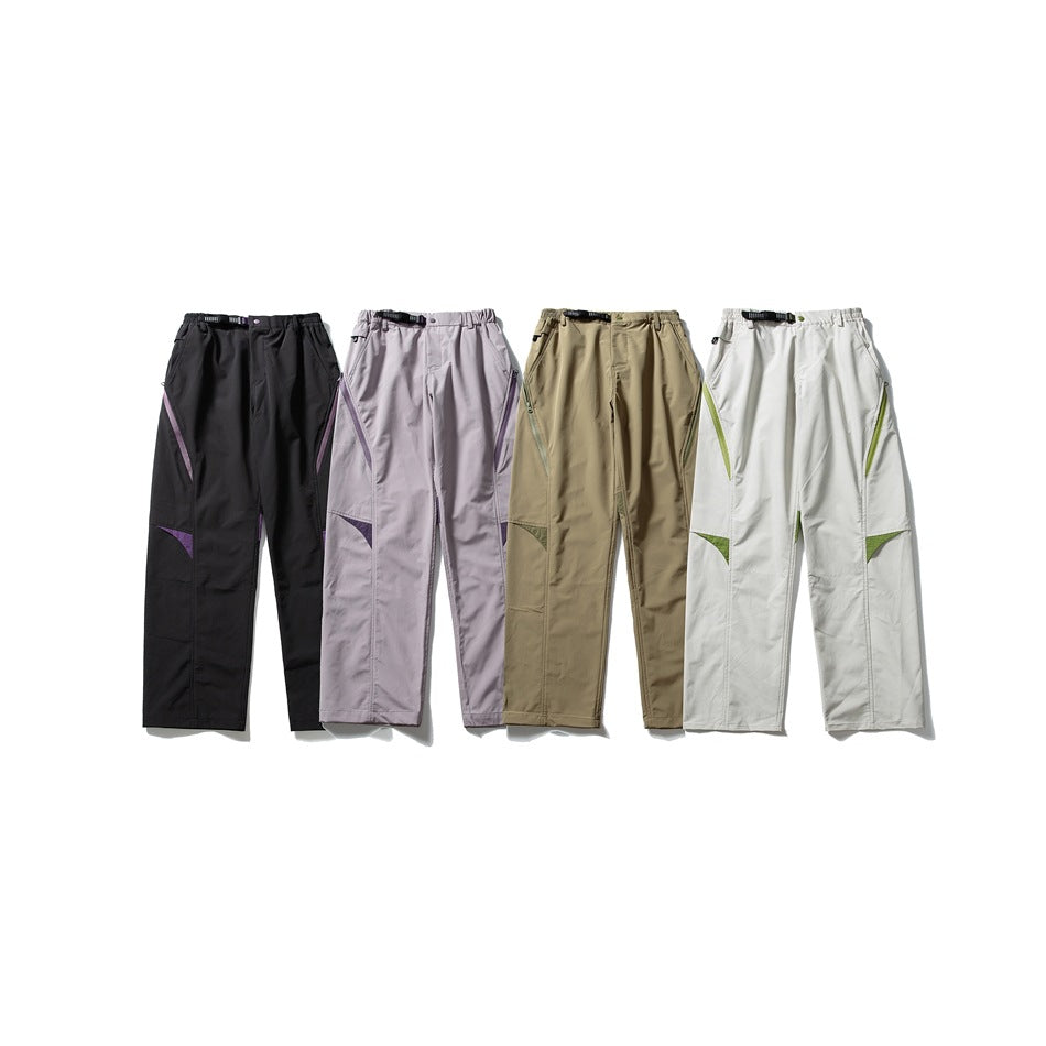 Four pairs of loose trousers shown flat, in black, pale lavender, khaki and white, with contrasting zip and knee accents.