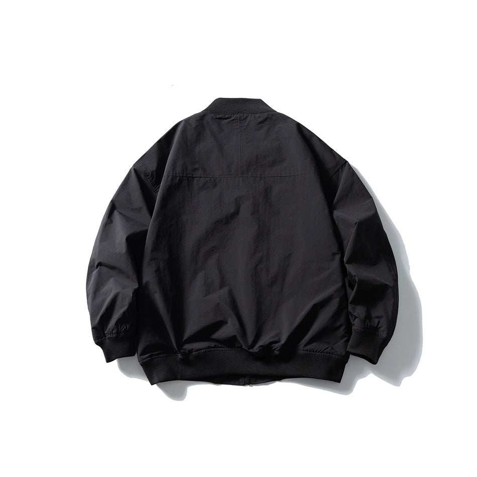 Back view of a black bomber jacket with ribbed collar, cuffs and hem and a horizontal yoke seam
