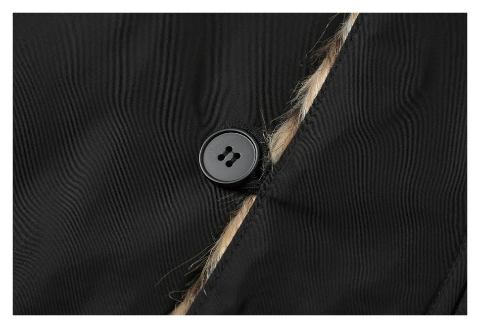 Close-up of a black garment button beside a narrow strip of brown and tan fur trim.