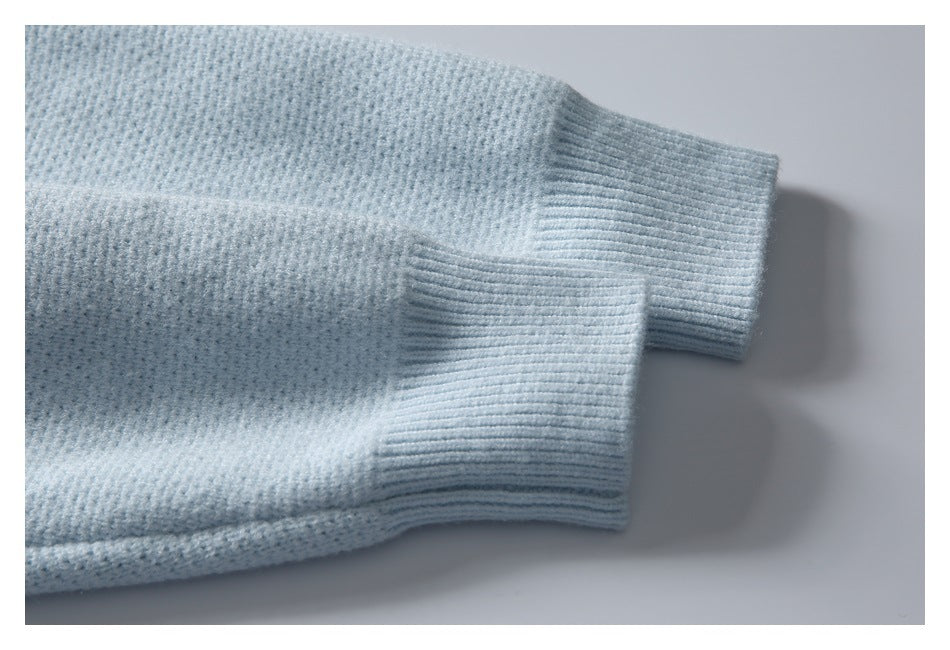 Pale blue knitted sleeves ending in wide ribbed cuffs, shown laid flat.