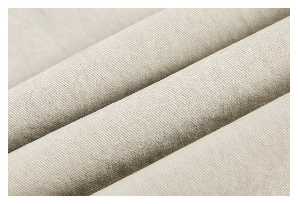 Close-up of light beige fabric showing a fine ribbed texture.