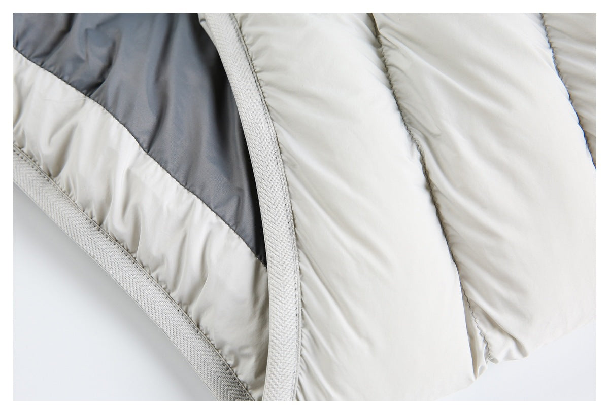 Close-up of ivory quilted padding beside a charcoal panel and textured light-gray binding.