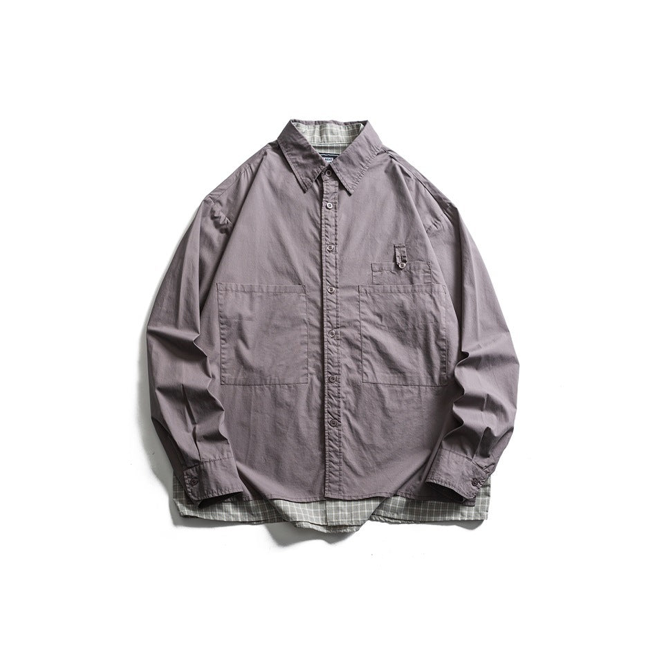 Gray long-sleeve button-up shirt with large patch pockets and a gray plaid layer at the collar and hem