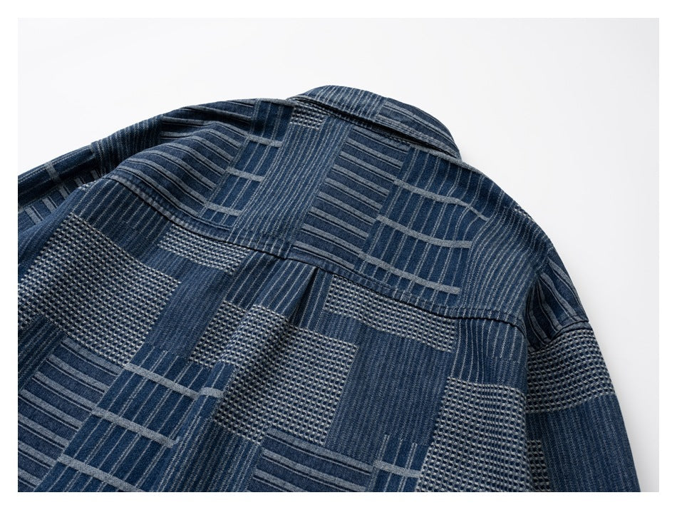 Back view of a dark blue shirt with a geometric patchwork pattern and a horizontal back yoke.