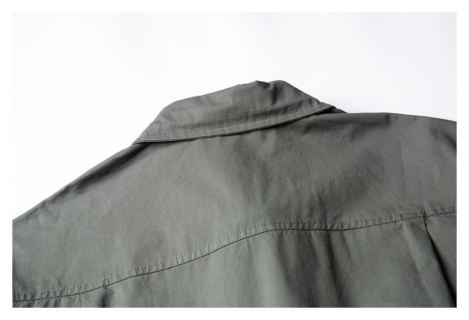 Close-up of the charcoal-gray shirt back showing its collar and curved shoulder yoke seam.