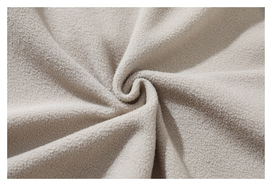 Close-up showing the soft, looped texture of light beige fleece fabric.