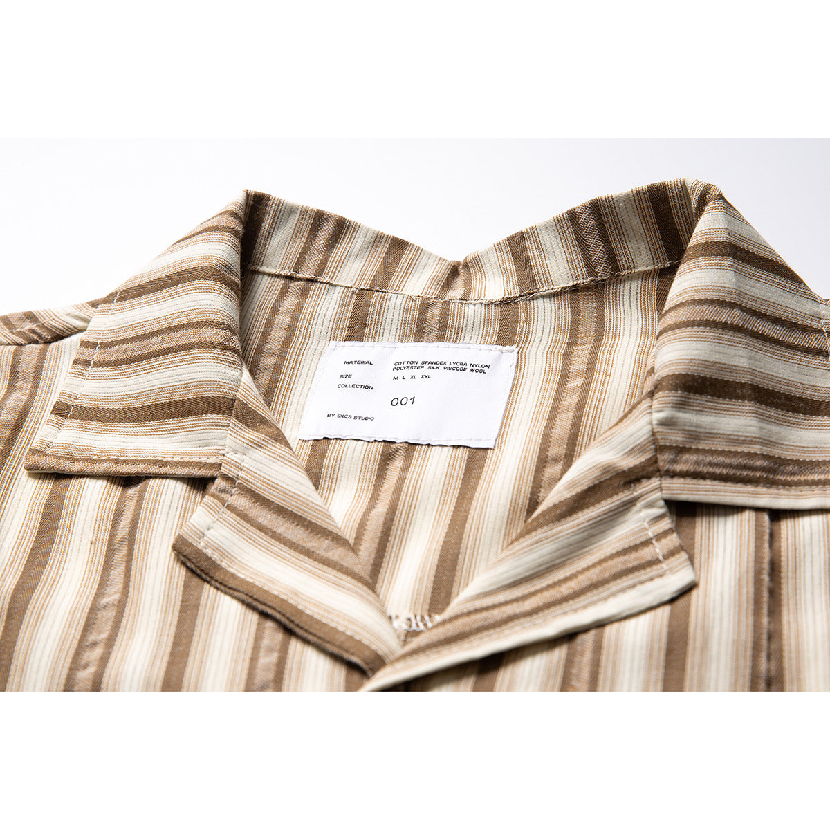 Close-up of a cream, tan, and brown striped shirt collar with a sewn-in label.