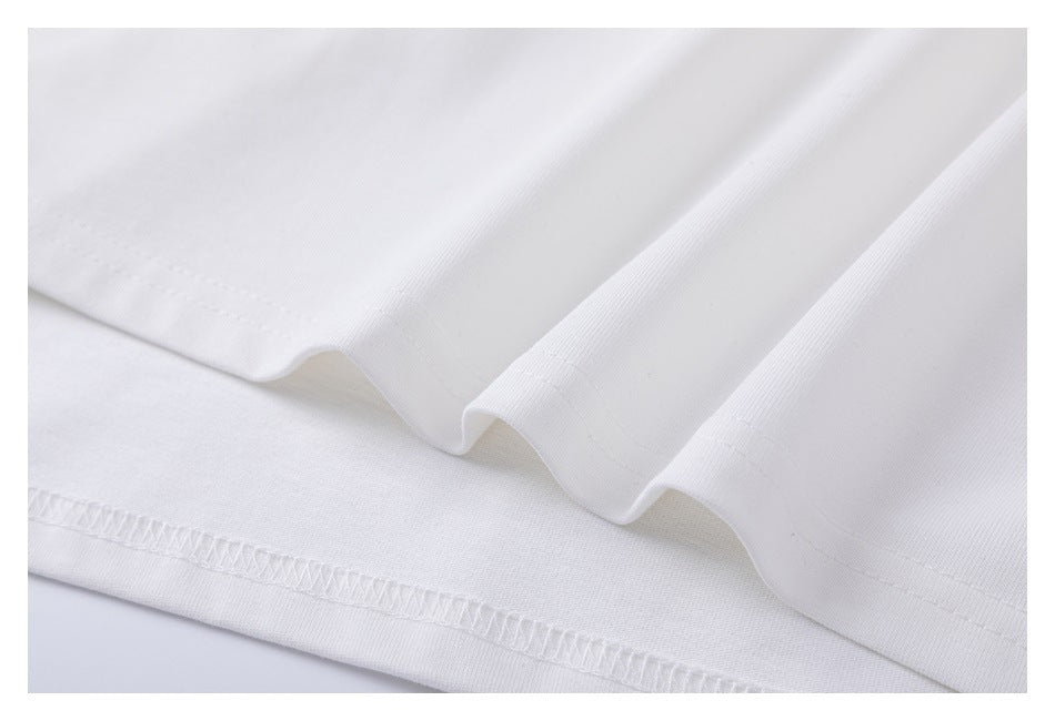 Close-up of the white T-shirt's bottom hem and stitching.