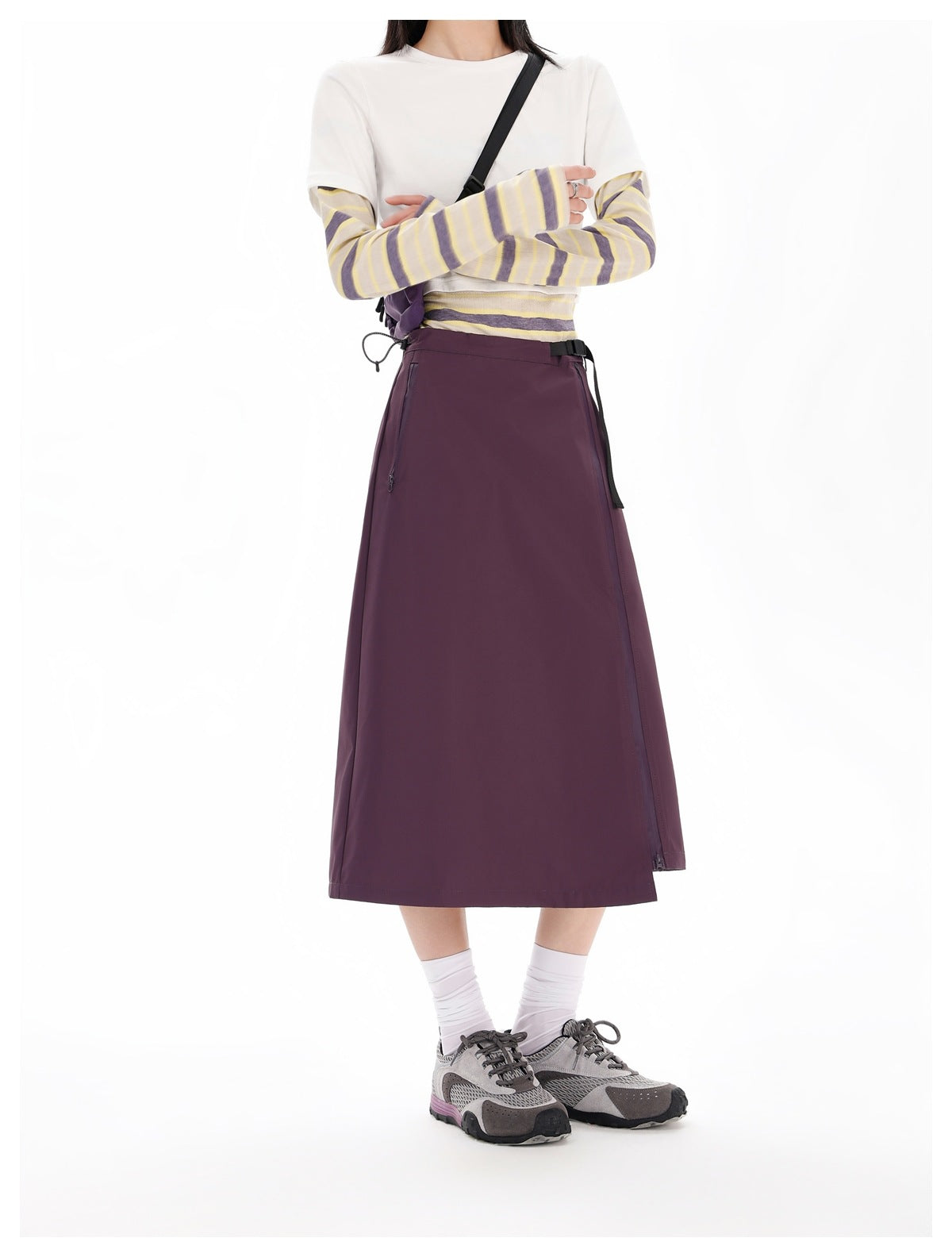 Model wearing the purple midi wrap skirt with a striped layered top, white socks and gray sneakers
