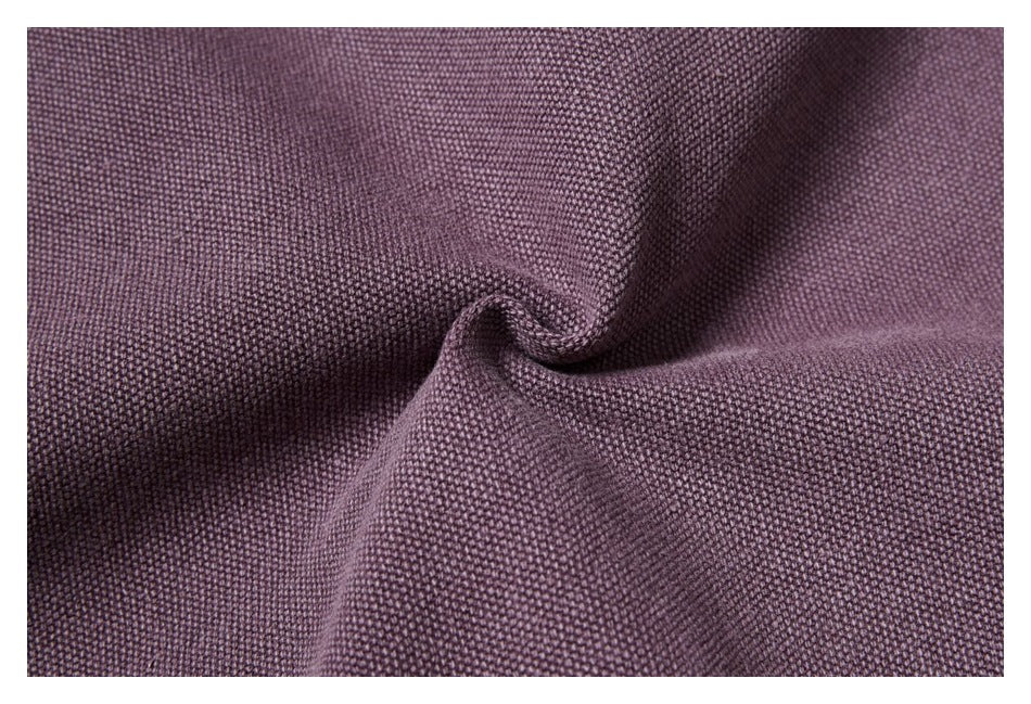 Macro view of textured muted purple fabric gathered into a soft fold.