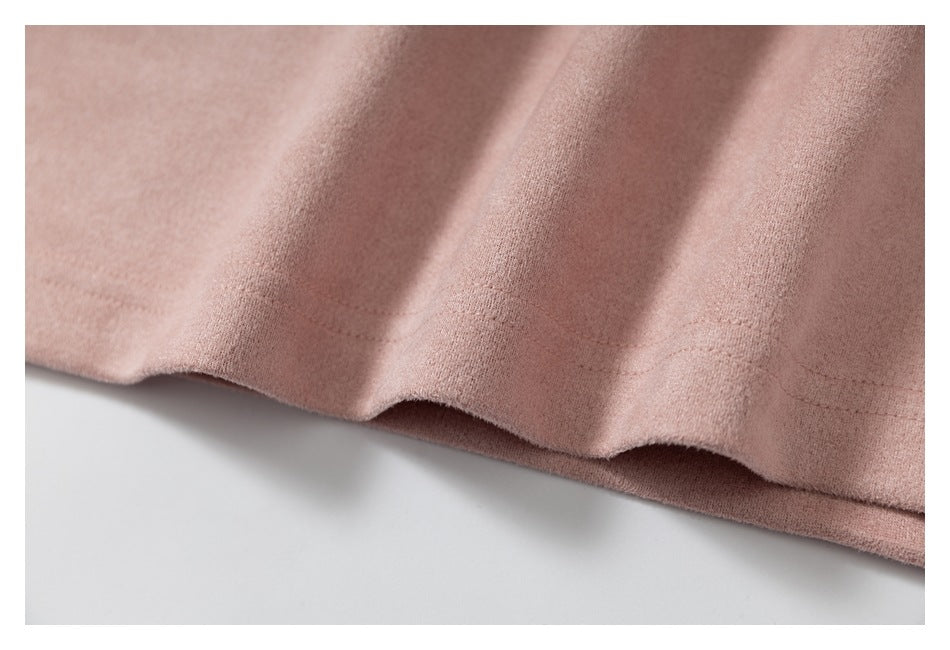 Close-up of the dusty pink garment's folded bottom hem and stitching.