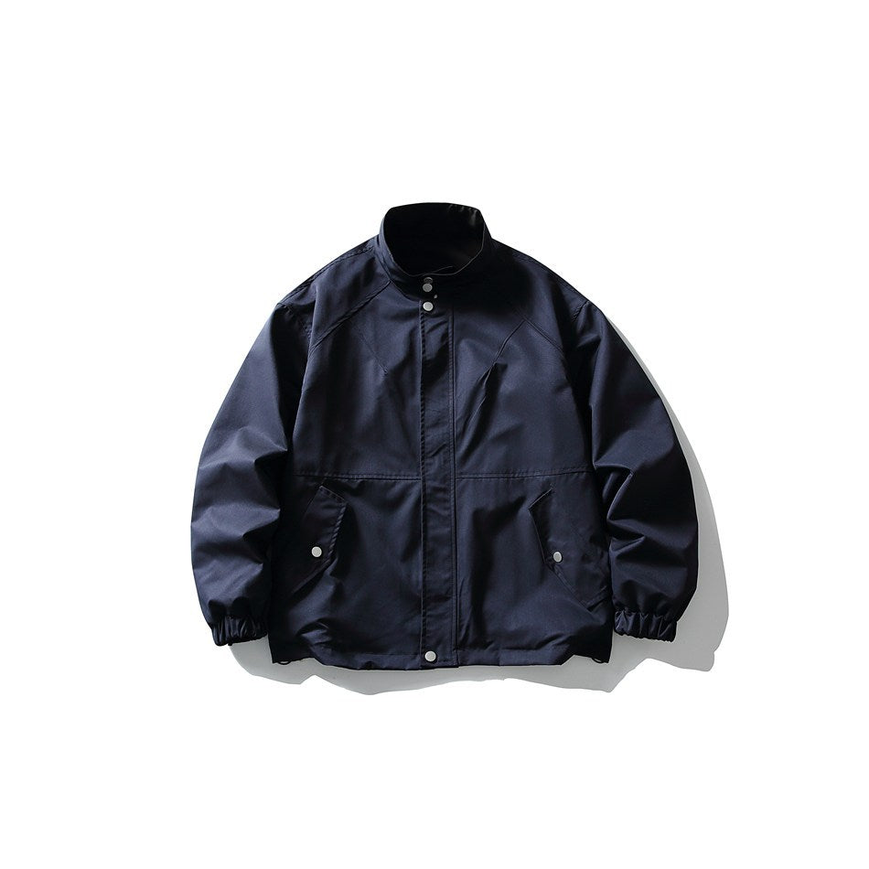 Navy stand-collar jacket flat lay, front view, with snap placket, snap-flap pockets and elastic cuffs