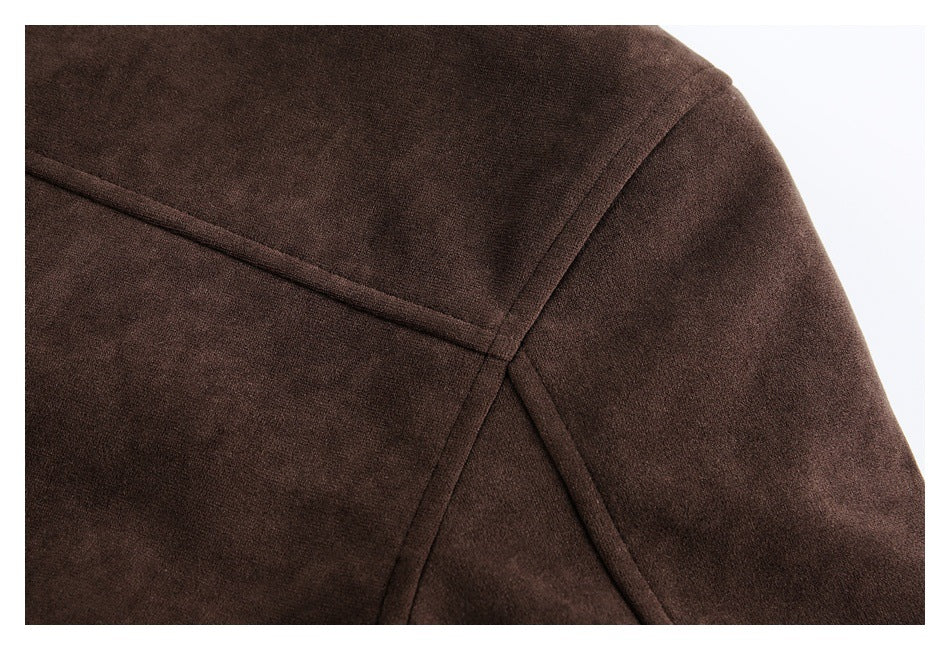 Close-up of stitched seams across the shoulder and back of a dark brown coat.