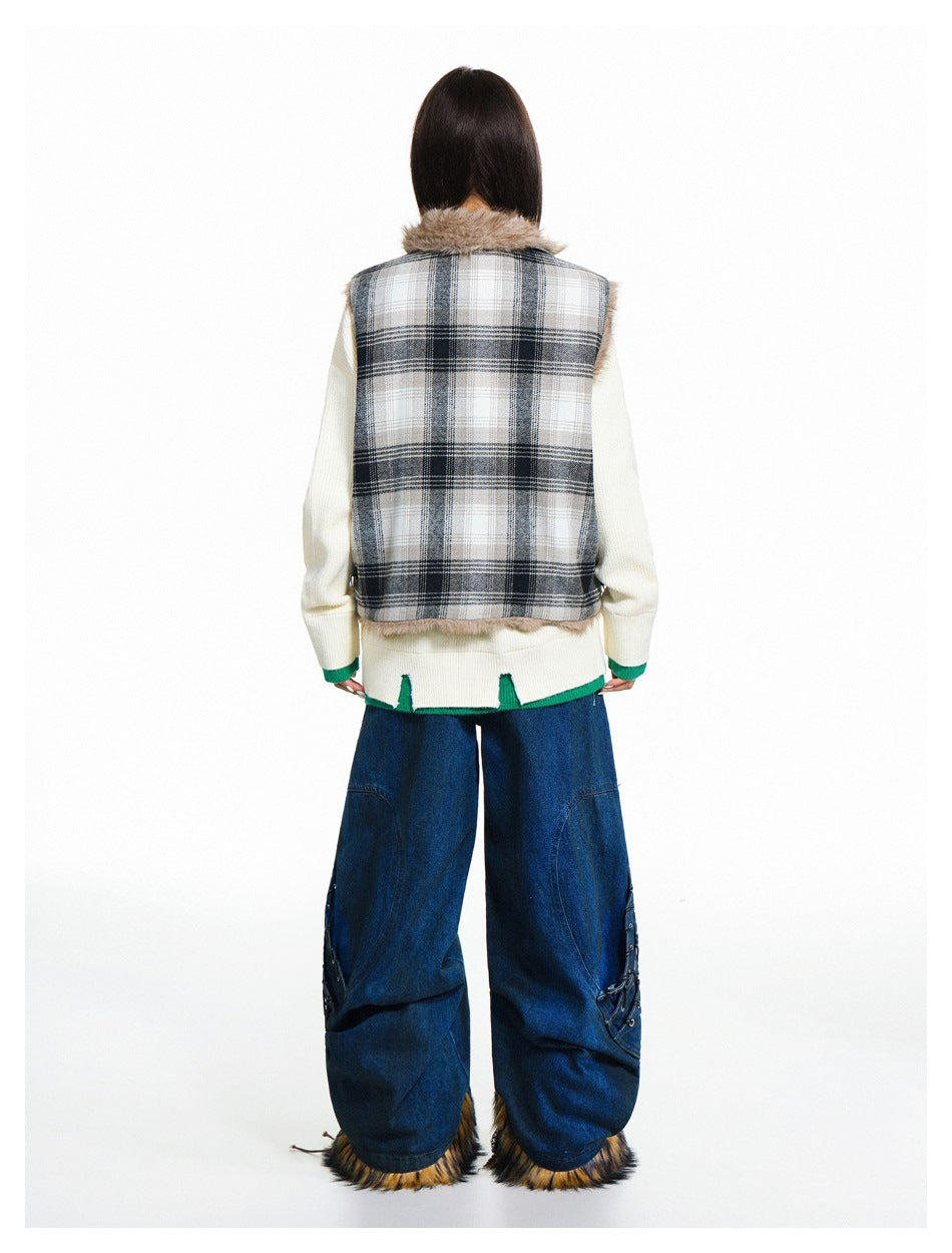 Back view of a model in a gray plaid vest with a fur collar, ivory sweater, and wide blue jeans.