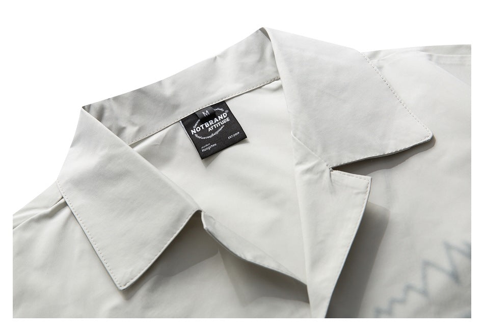 Off-white shirt collar and upper chest shown close up, with a black neck label.