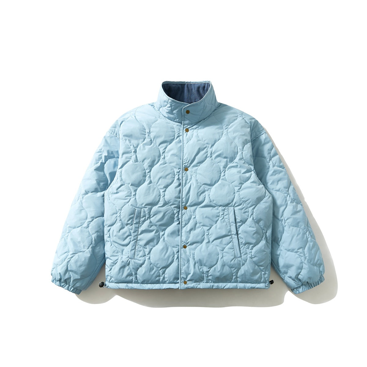 Front view of a pale blue jacket with circular quilting, a high collar, snap closure, and gathered cuffs.