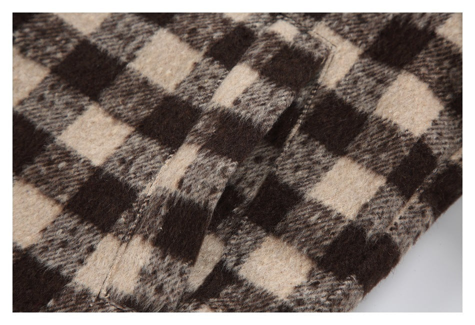 Close-up of the jacket's fuzzy brown and beige check fabric and a stitched seam.