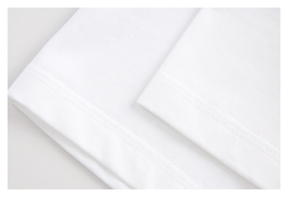 Close-up of white garment hems with parallel rows of stitching.