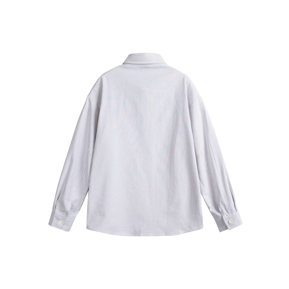 Back view of a pale gray-and-white vertically striped long-sleeve button-cuff shirt laid flat on white.