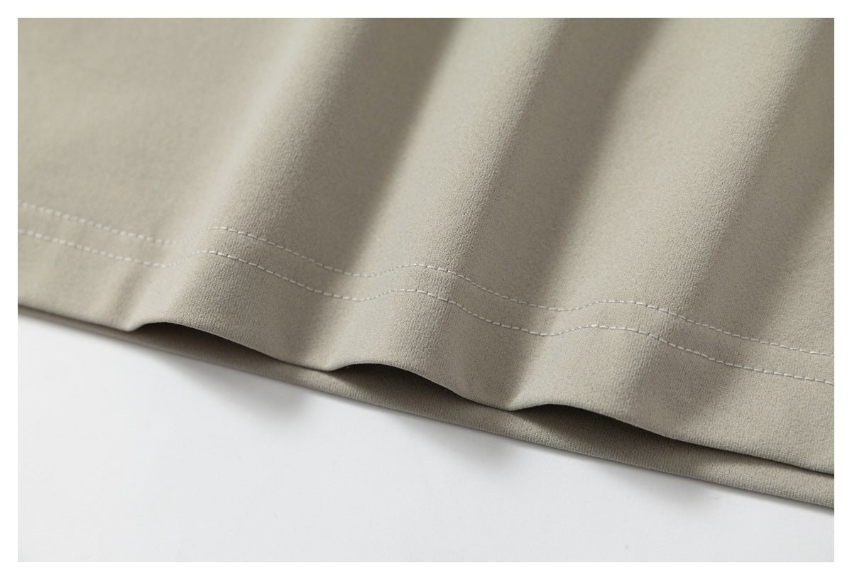 Close-up of the light taupe T-shirt's double-stitched bottom hem.