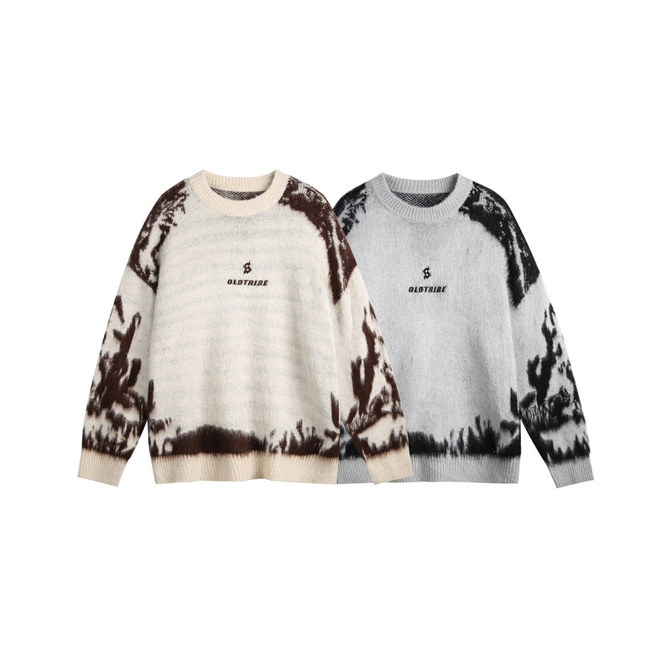 Two crew-neck sweaters shown from the front: ivory with brown patterning and gray with black patterning.