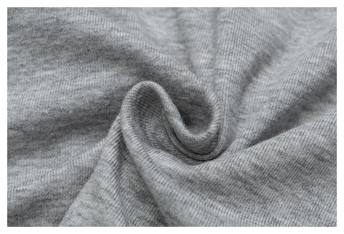 Close-up of gray heather T-shirt fabric gathered into a fold, showing its knit texture.