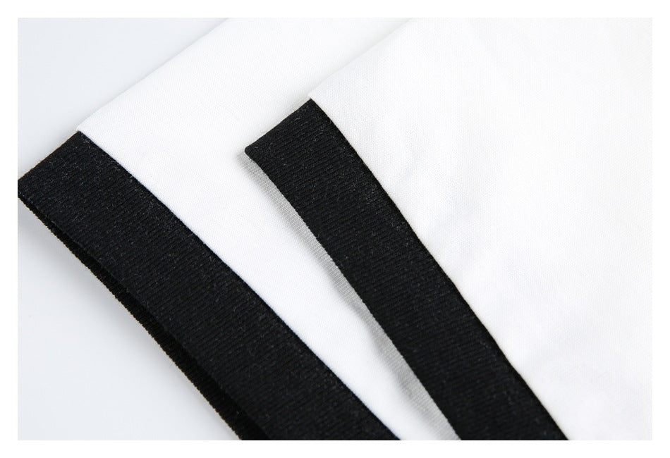 Close-up of two white sleeve edges with wide black ribbed cuffs.