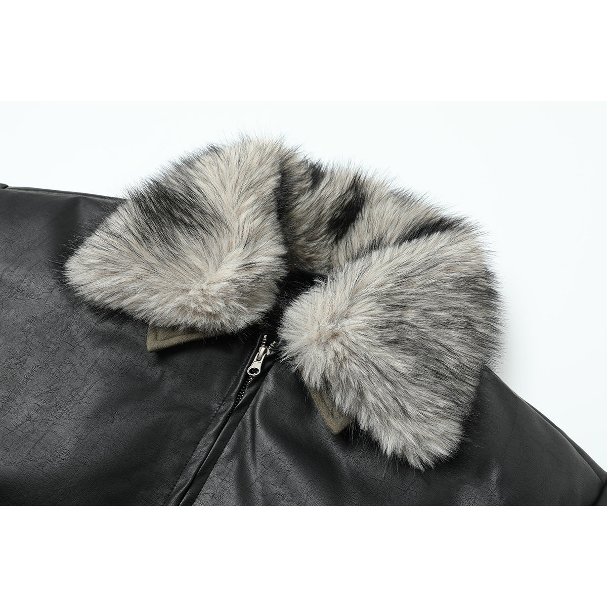Close-up of a black jacket’s gray-and-black faux-fur collar and front zipper.