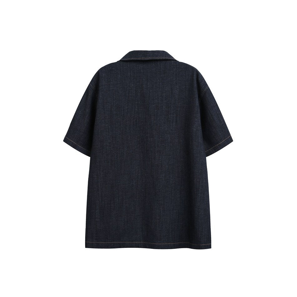 Back view of dark indigo short-sleeve shirt with collar and plain textured back, flat lay