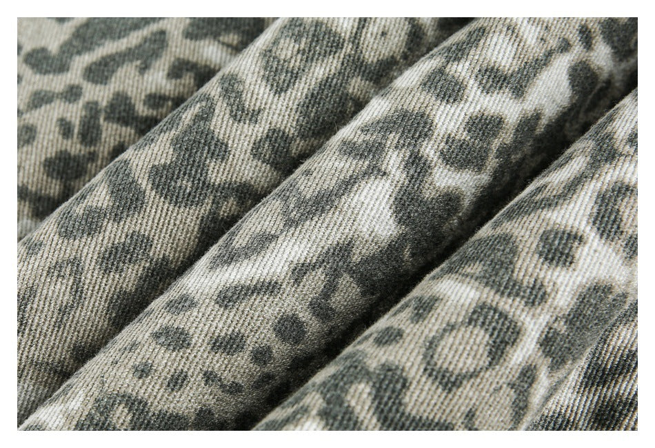 Macro view of the jacket's gray-green and cream animal-print fabric.