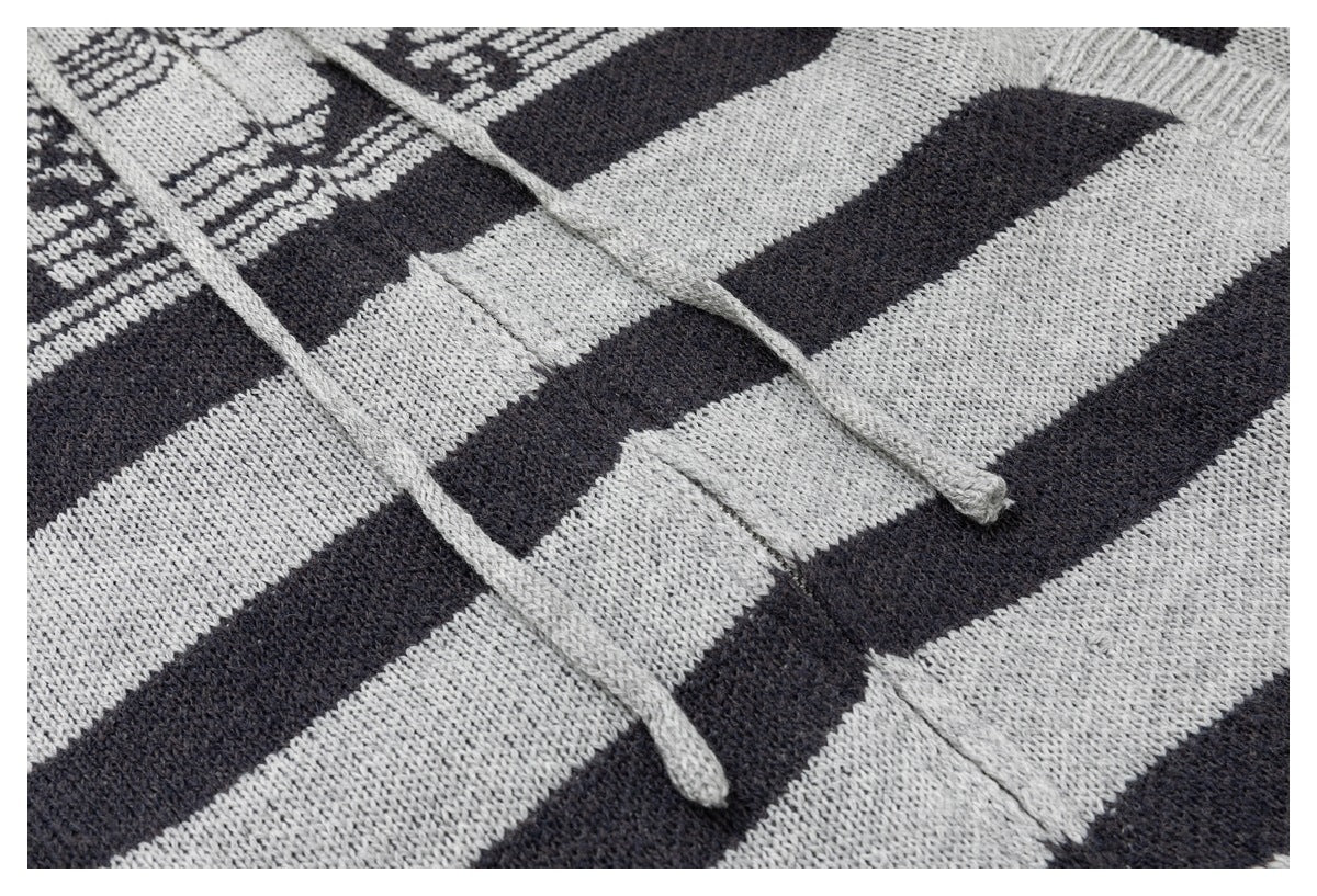Close-up of gray drawstrings against the charcoal-and-gray striped knit front.